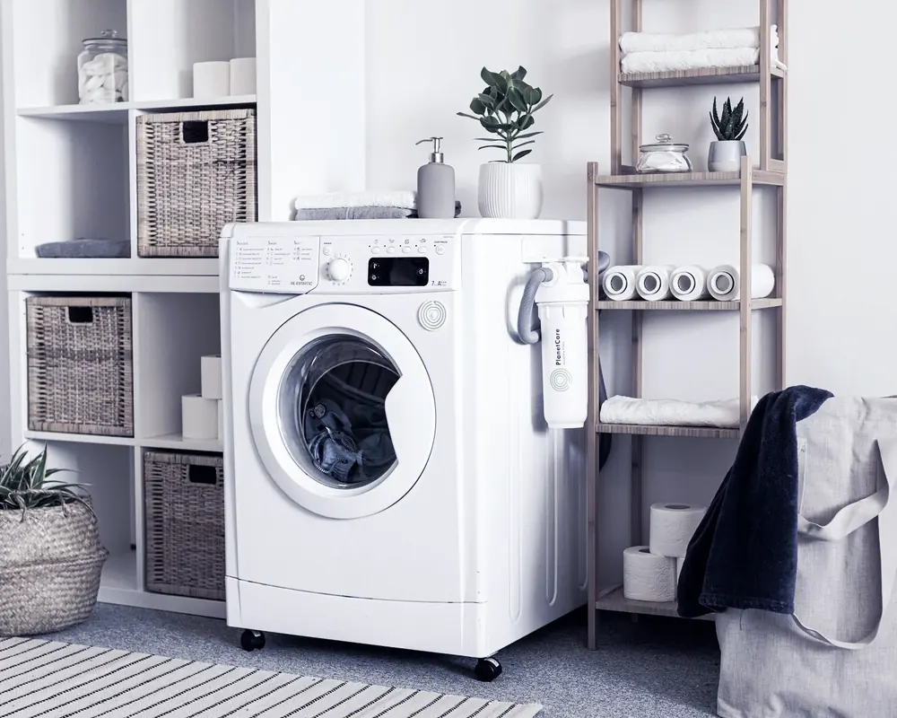 A white washing machine in a bright utility room