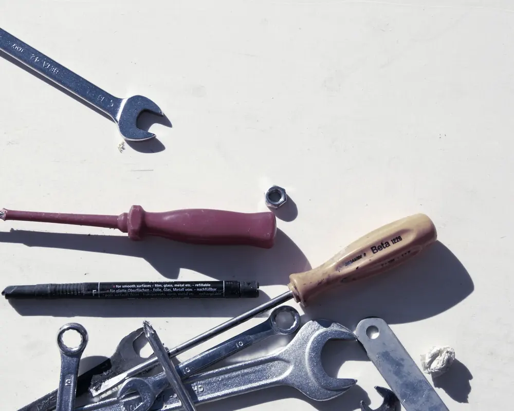 Spanners and screwdrivers laid out on a workbench