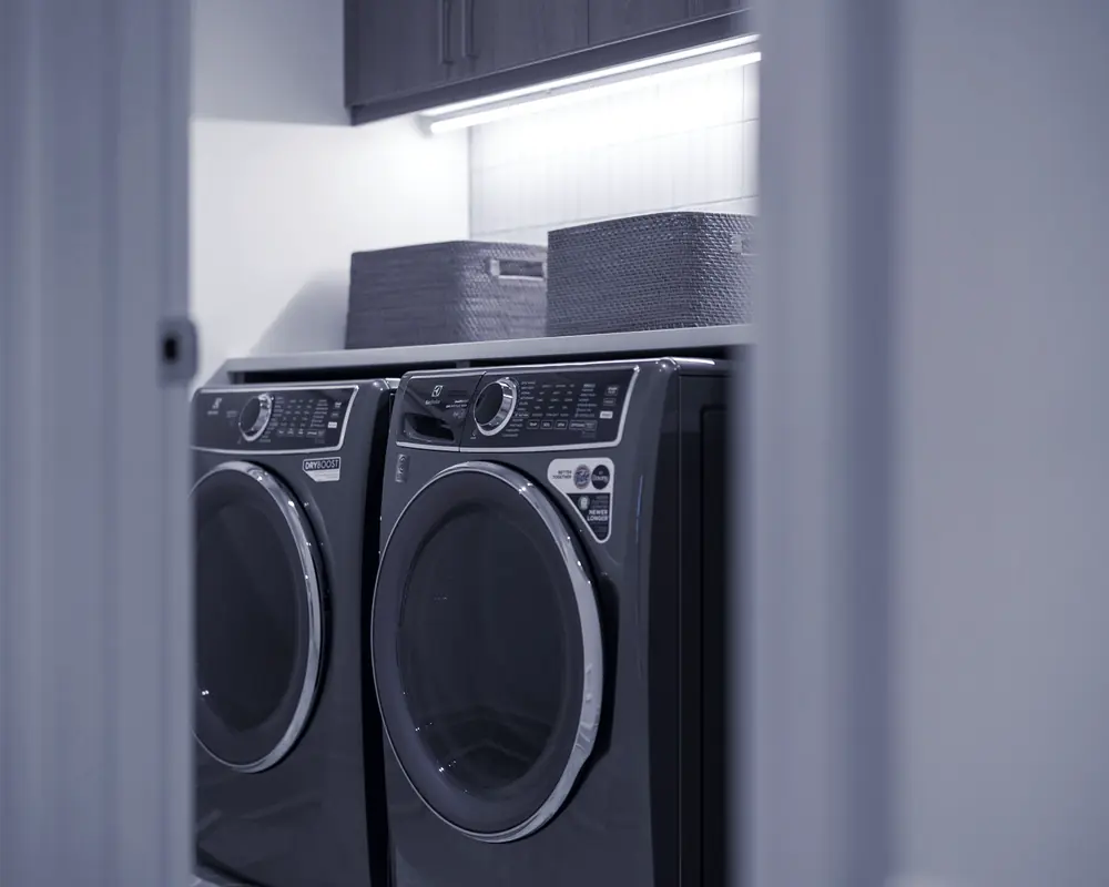 A washing machine and tumble dryer side by side in a utility room