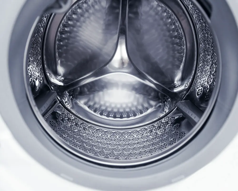 Inside the stainless steel drum of a front-loading washing machine